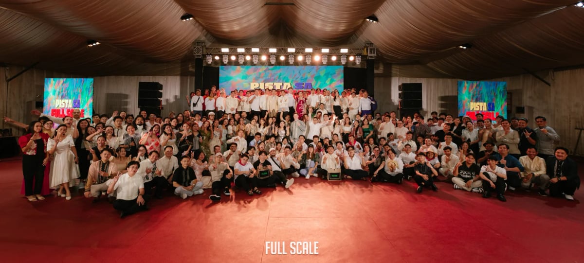 Full Scale employees dressed in Filipiniana attire posed together at the 