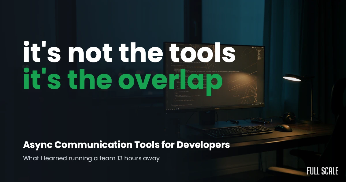 A computer monitor and keyboard on a dark desk with the text: "it's not the tools it's the overlap. Async Communication Tools for Developers.