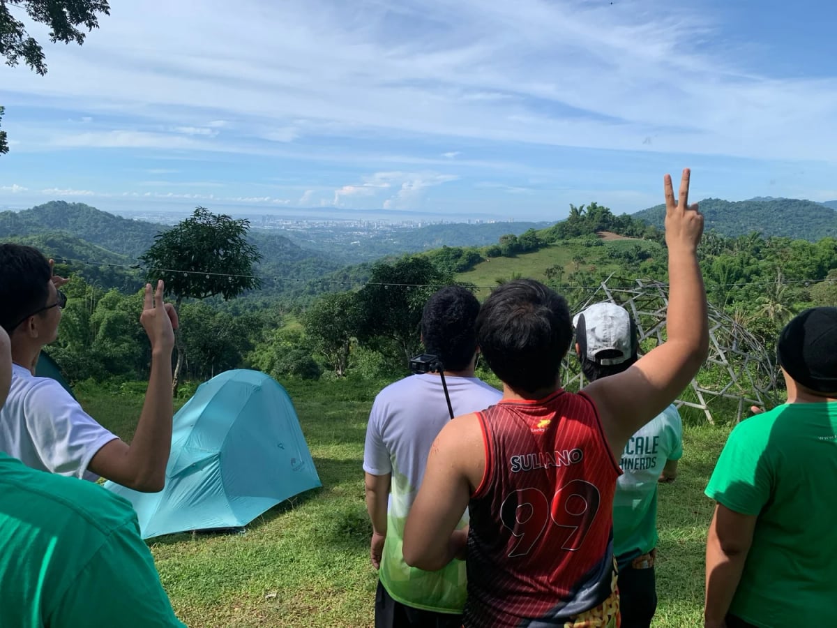 Full Scale employees at a hillside campsite together during a motocamping club trip