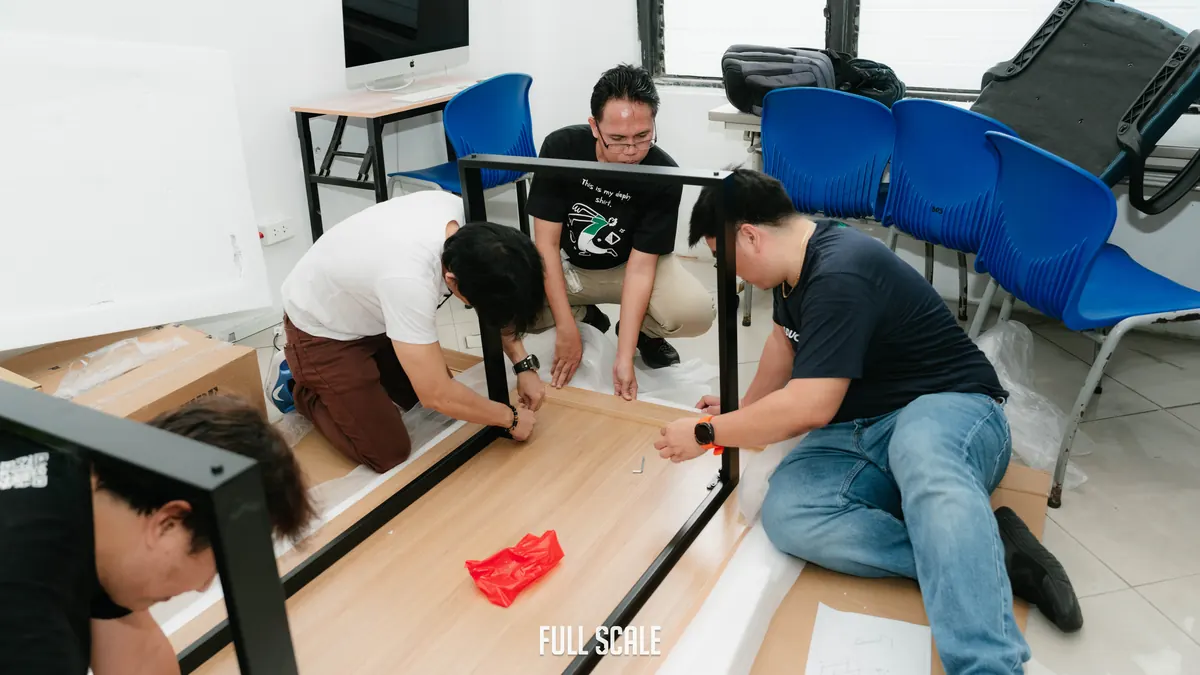 Full Scale volunteers assembling desks and setting up donated computers at Passerelles Numériques